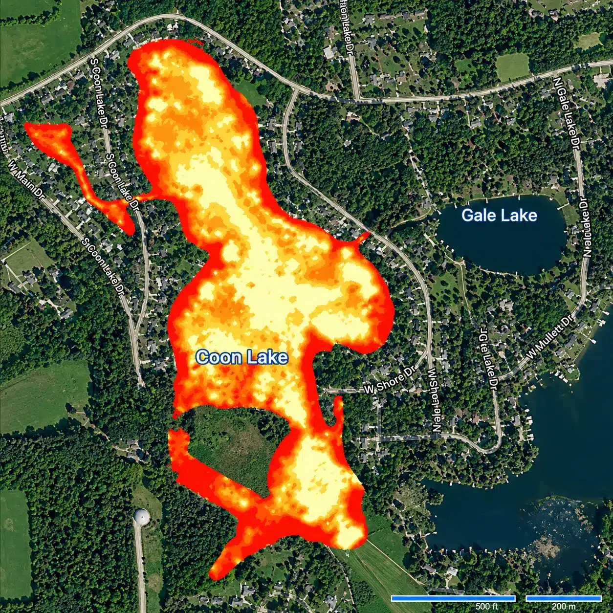 Aerial map showing Coon Lake highlighted in red, orange, and yellow tones, surrounded by roads, houses, and forested areas. Gale Lake is labeled to the east.